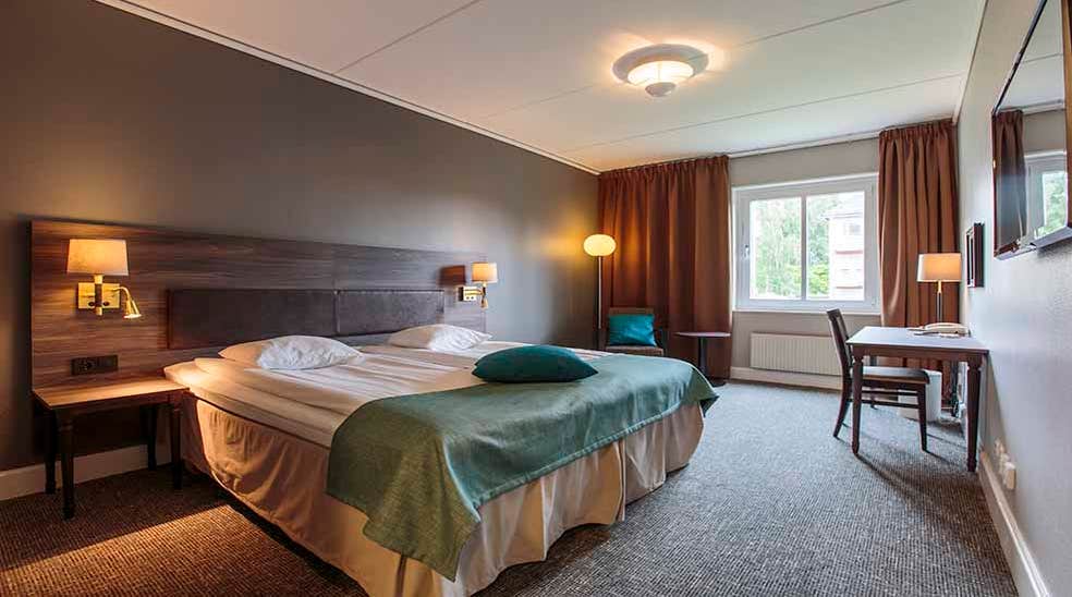 Yleiskatsaus kahden hengen Standard-huone kahden hengen vuoteella ja pöydällä Clarion Collection Hotel Uman -hotellissa, Uumajassa